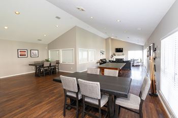 A dining room with a dark wood table and chairs.